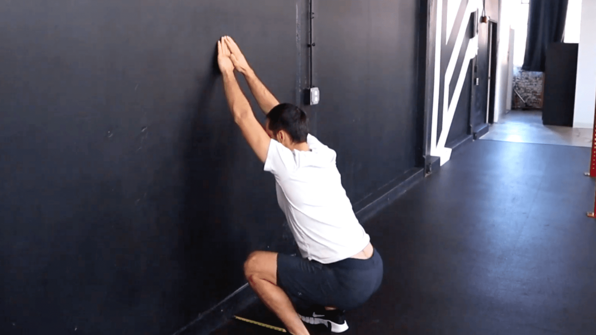 A person performs the squat therapy assessment.