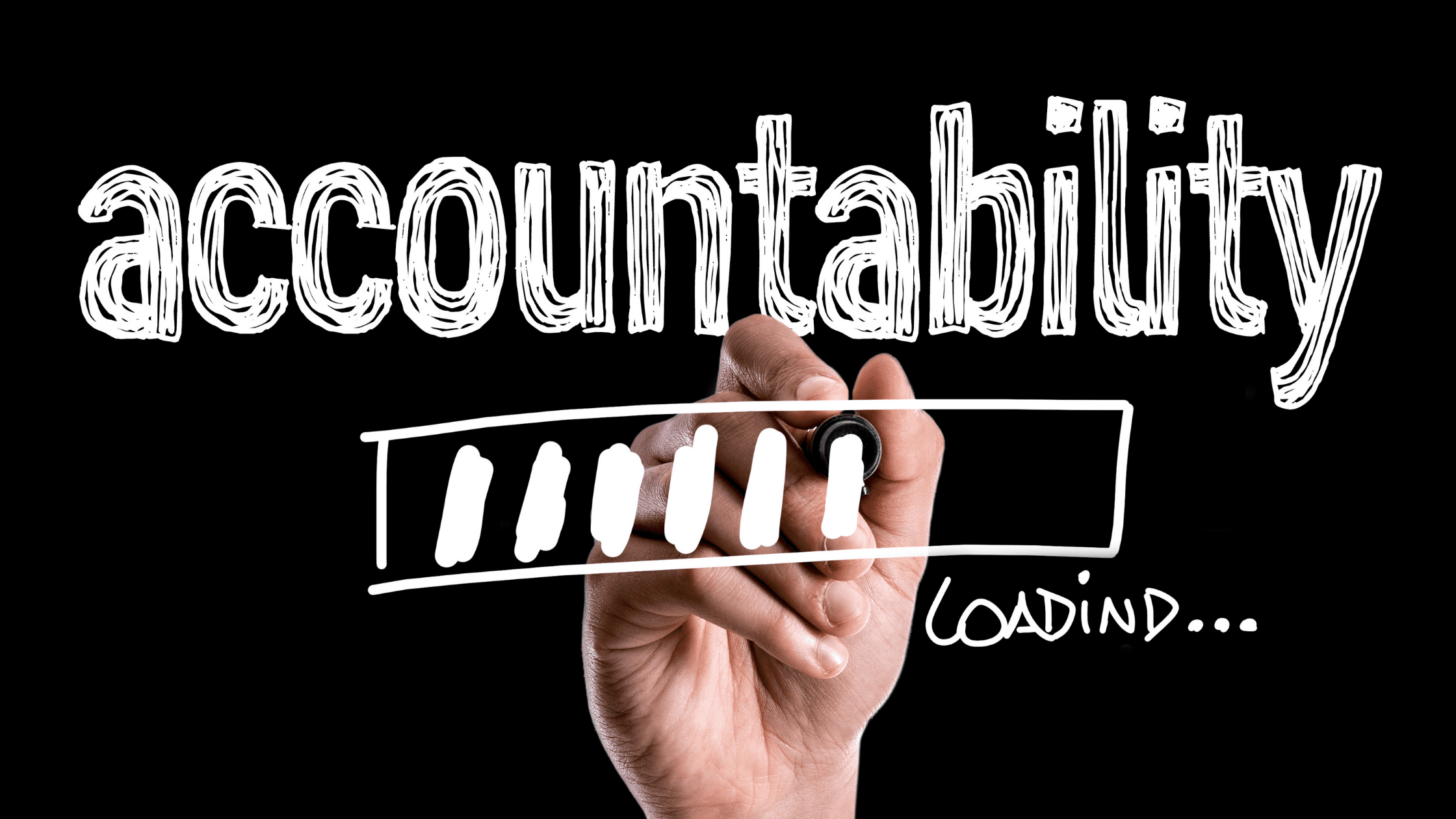 Person writes the word accountability.