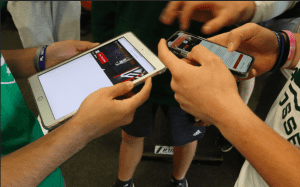 Students using PLT4M app on tablet and phones.