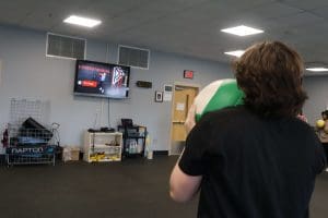 Students hold medballs during a fitness PE class.