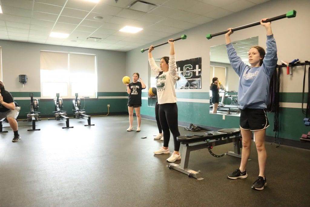 Students complete a fitness workout in physical education class.