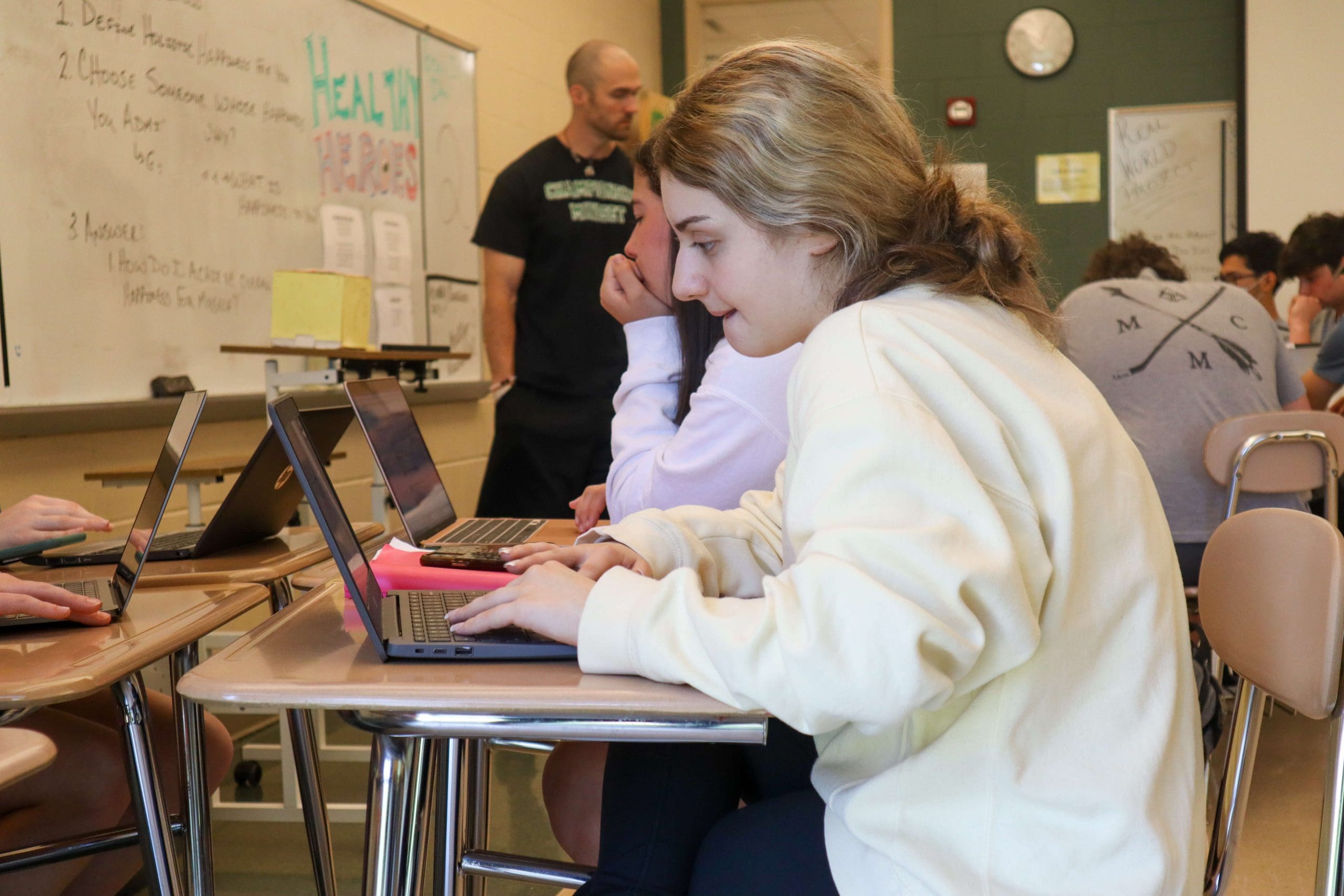A student looks at their laptop during a physical education class.