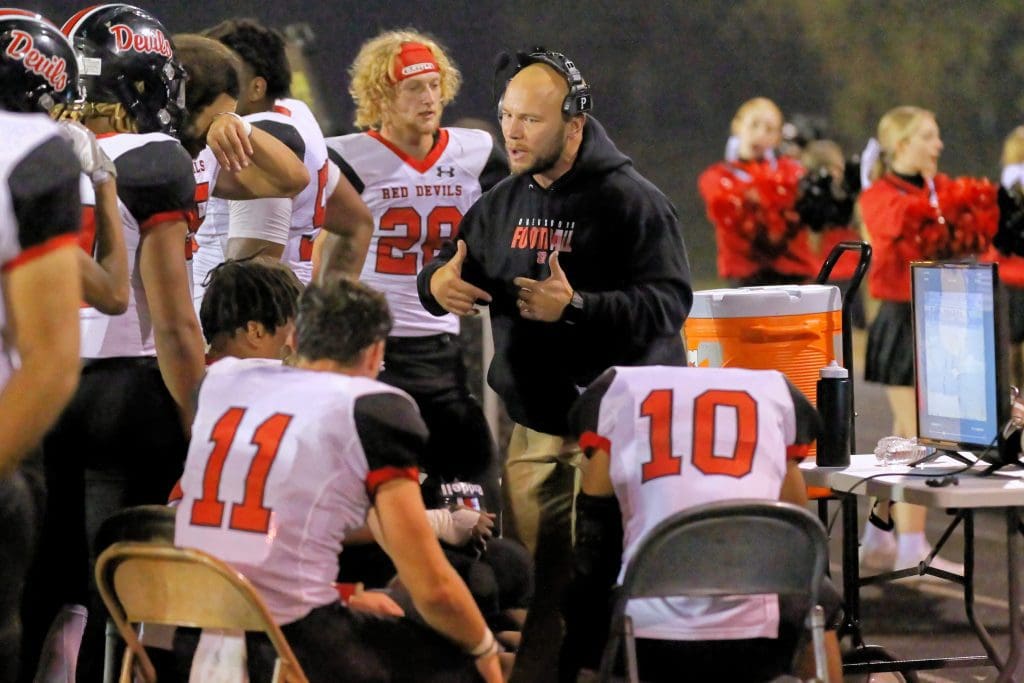 Blake Roberts coaches football players during an Owensboro football game.