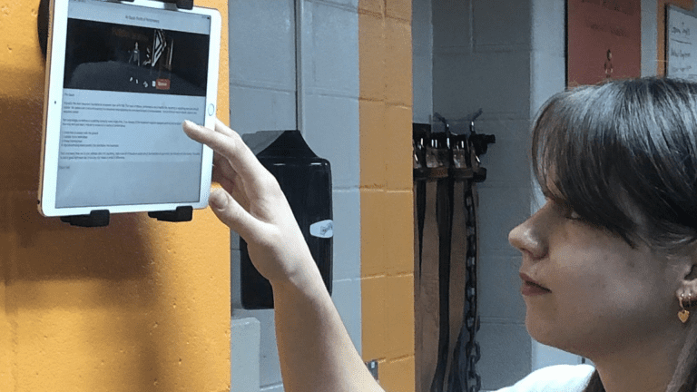 Quincy student uses technology on an ipad to access PLT4M.