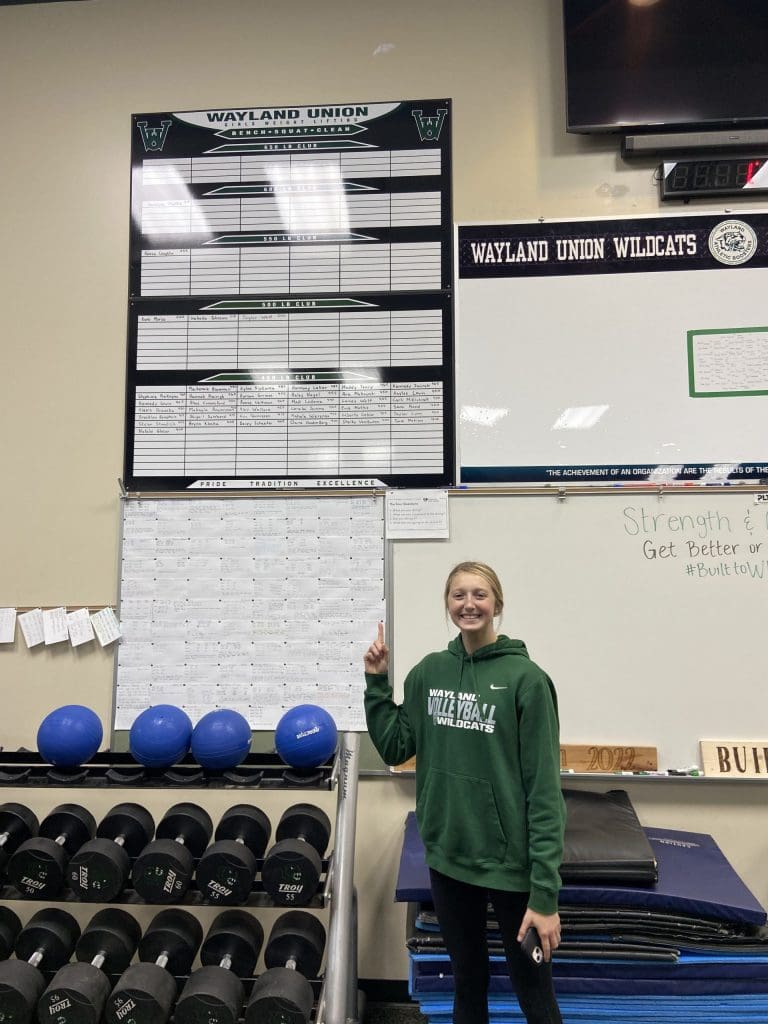 A student points at a leaderboard in Wayland Union physical education class.