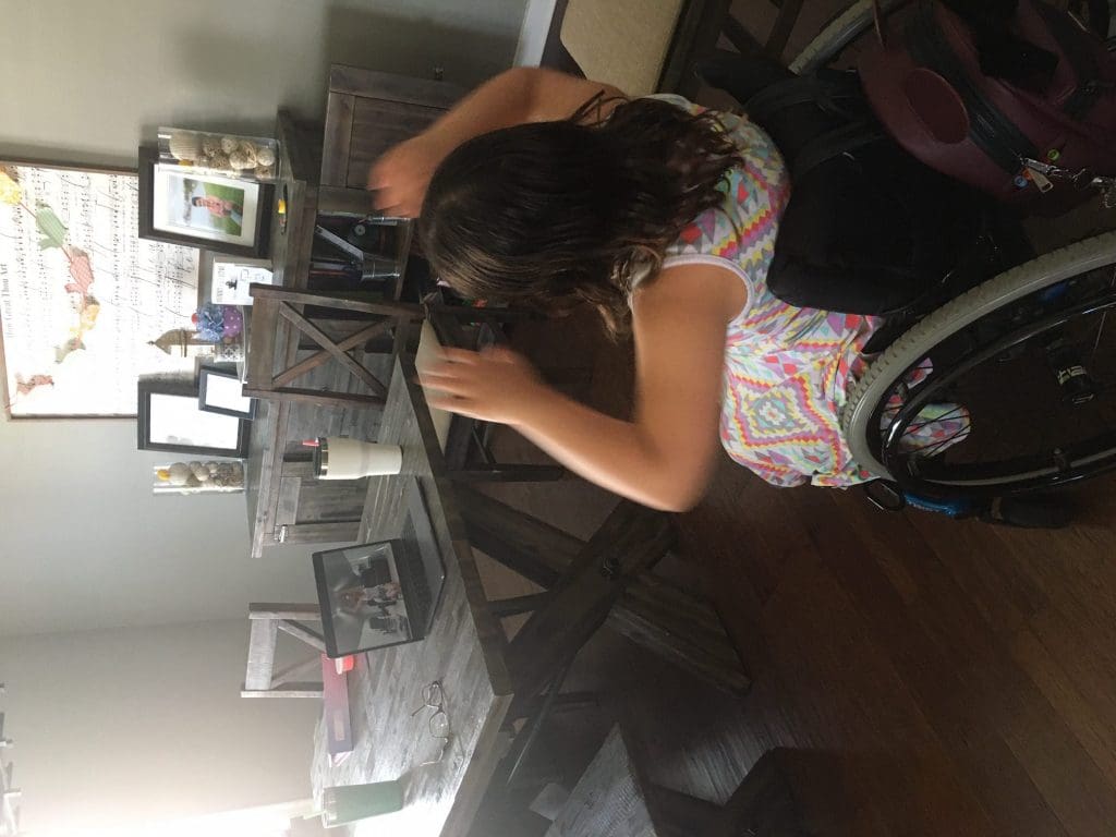 Youth participating in a virtual fitness class at home.