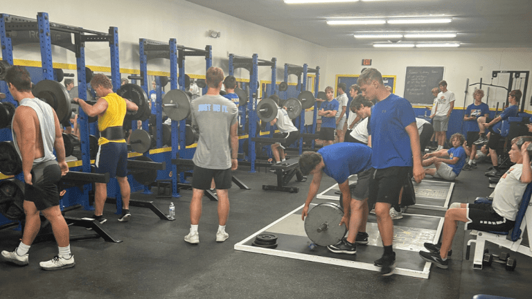 Crowded weight room at Marion High School. Athletic success starts before school.