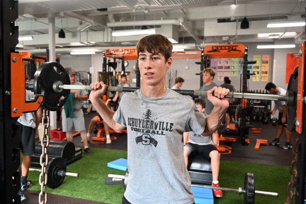 Schuylerville football player in the weight room during summer football workouts.