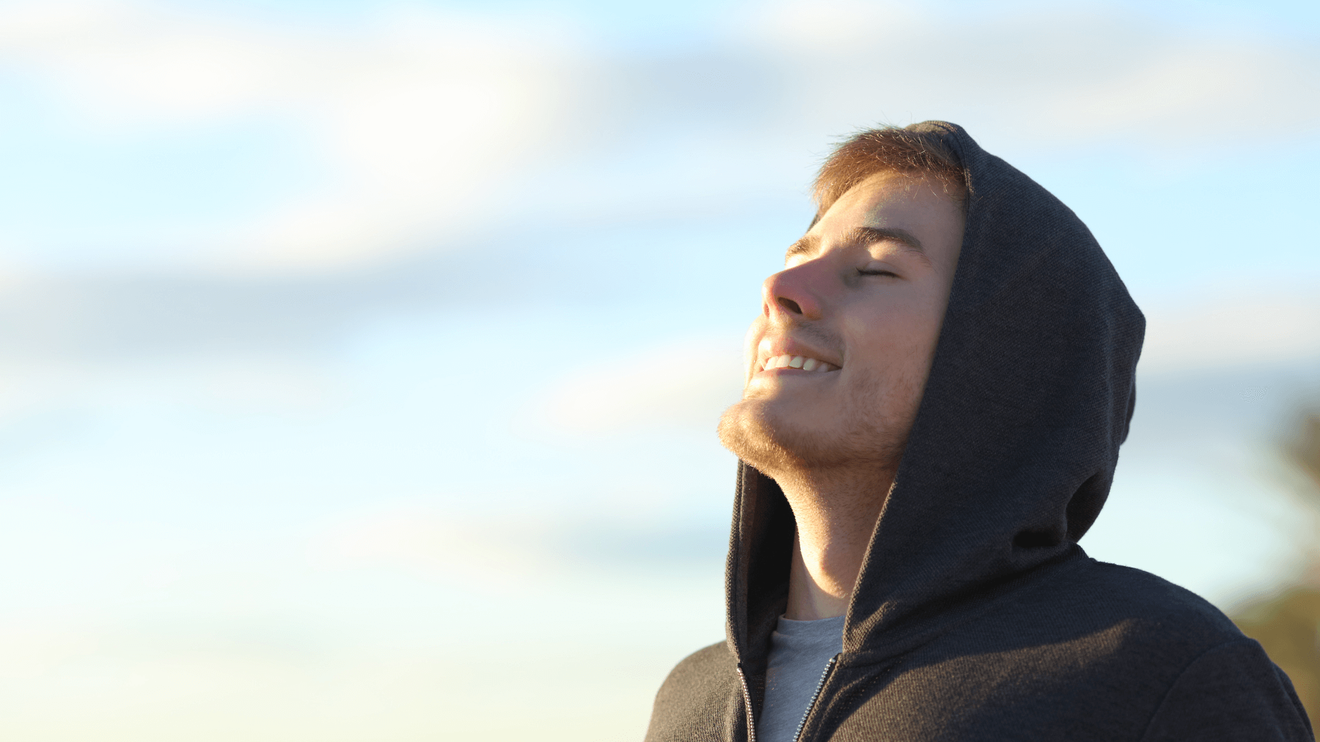 Student takes deep breath with eyes closed.