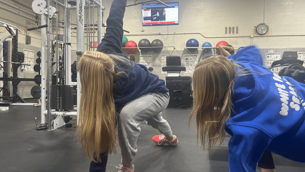 Students warming up at Frontier with PLT4M displayed on the TV.