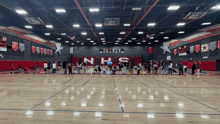 Double PE class at North High School in California completing a bodyweight bootcamp workout.