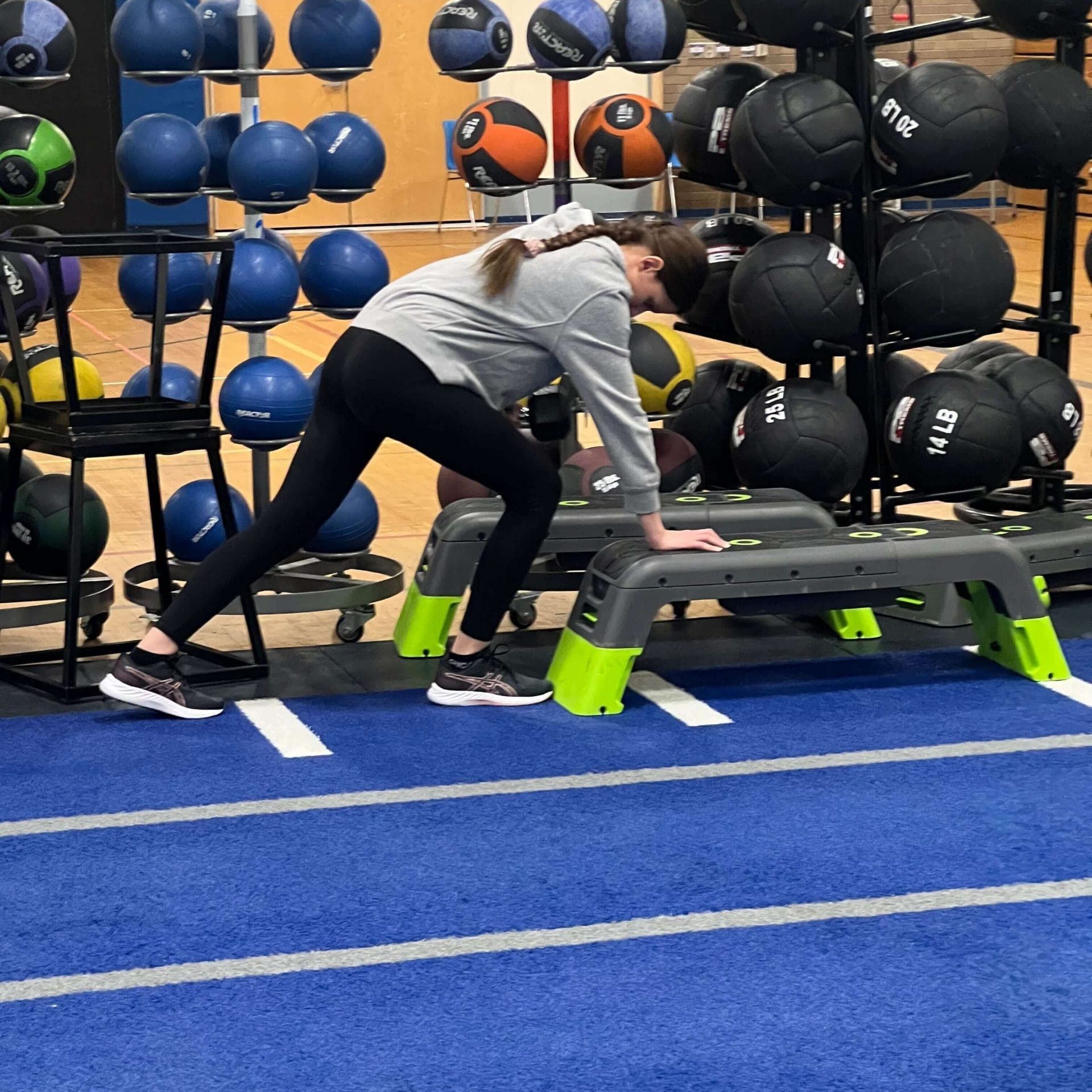 A female student does a bent over row.